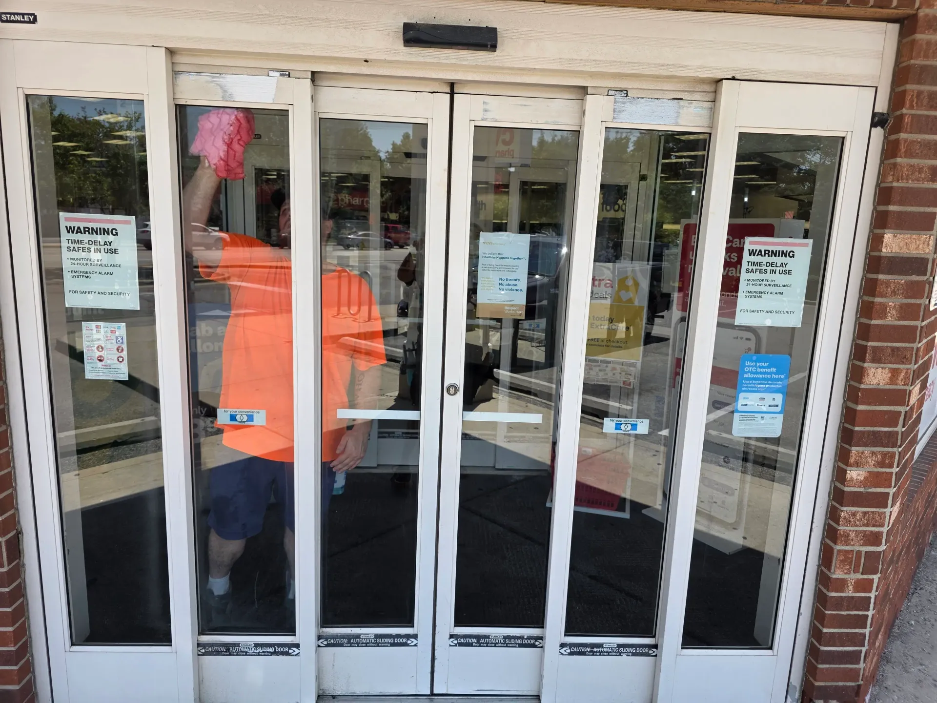 Commercial glass entrance doors reflecting the building exterior.